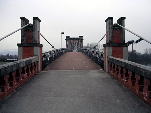 This is a photo of a bridge in Trévoux France that crosses over the Saône River.